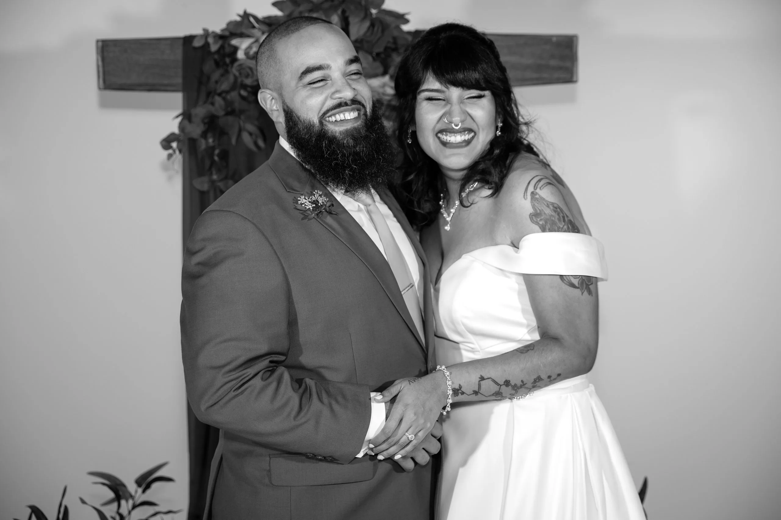 Couple embracing and laughing, black and white wedding photograph