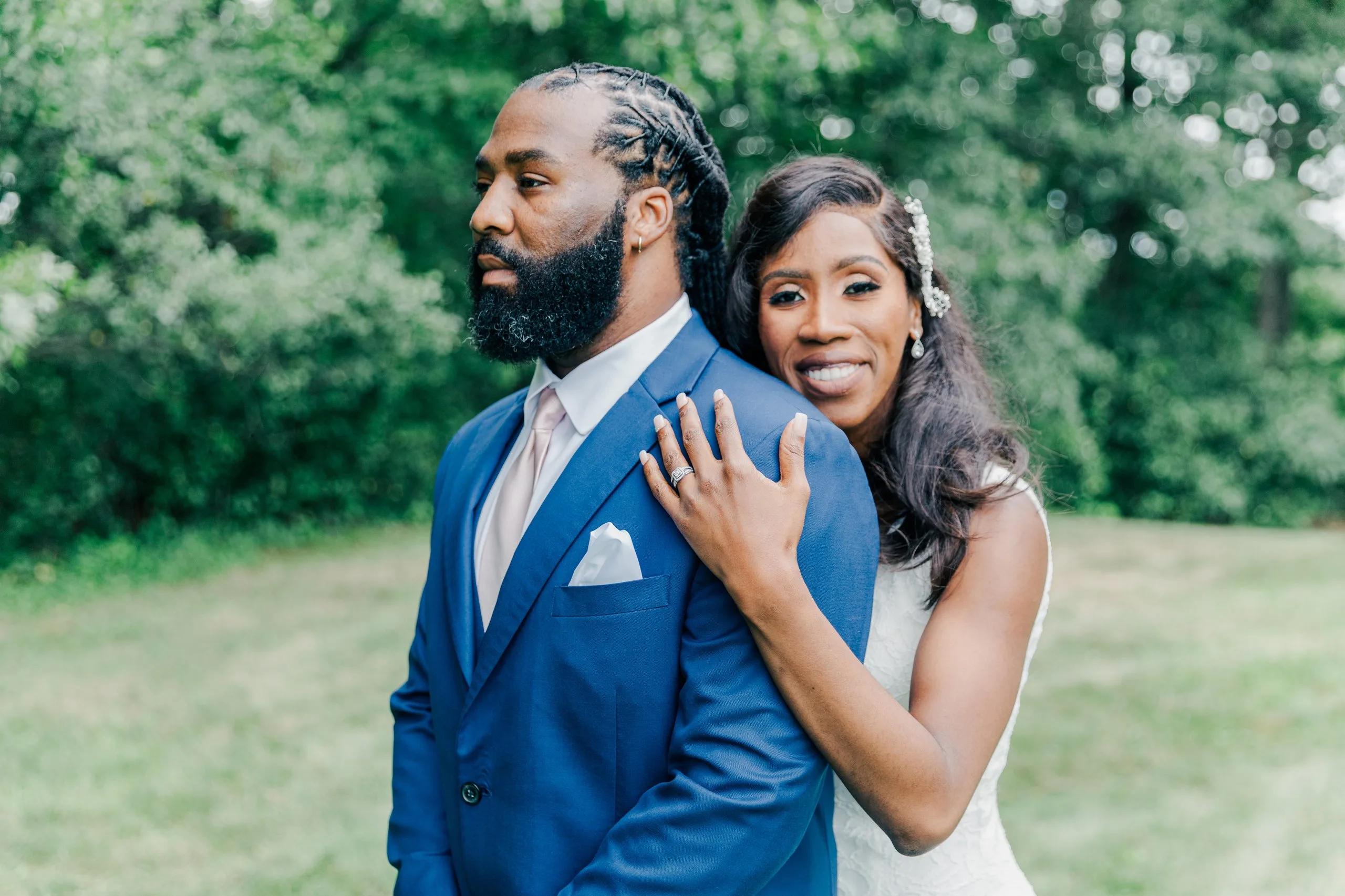 Bride and groom in a green New England field