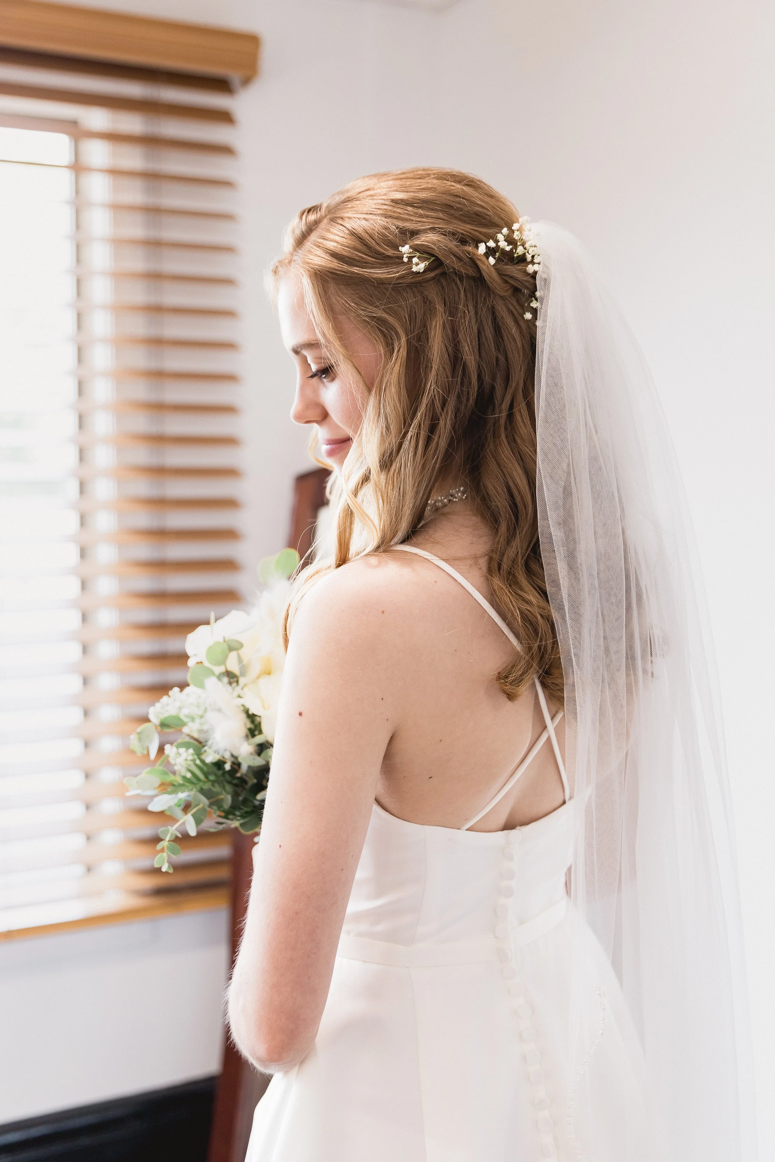 Bride backlit through her veil